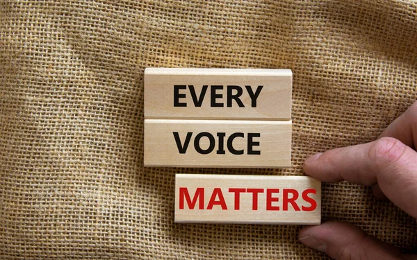 Concept words \'every voice matters\' on wooden cubes on a beautiful grey background. Business concept. Copy space.