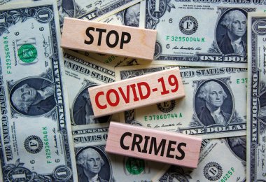 'COVID-19 suçları durdurun' kavramını dolarlardan güzel bir arka planda tutun. Uzayı kopyala İş ve covid-19 salgın konsepti.