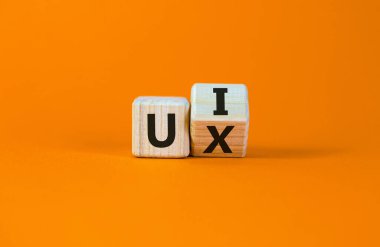 UX tasarımı veya UI tasarımı. Küpü çevirdim ve 'UX' kelimesini 'UI' olarak değiştirdim. Güzel turuncu arka plan. İş konsepti. Boşluğu kopyala.