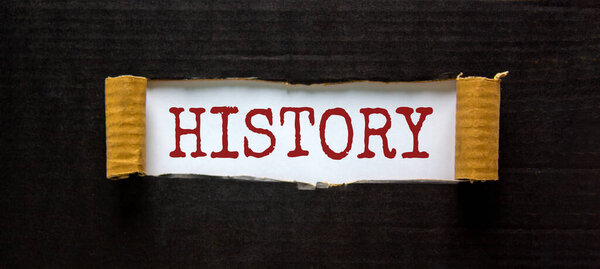 History uncovered concept. The word 'history' appearing behind torn black paper. Beautiful background. Business concept.