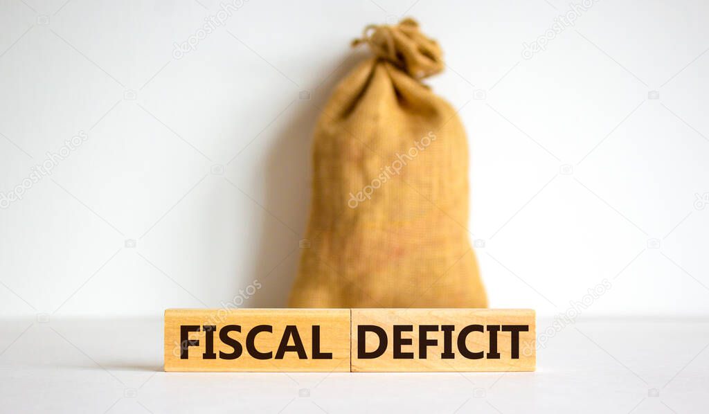 Fiscal deficit. Concept words 'fiscal deficit' on blocks on a beautiful white background. Large canvas bag. Business and fiscal deficit concept. Copy space.