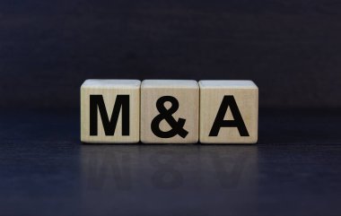 Mergers and acquisitions symbol. Concept words 'M and A - Mergers and acquisitions' on wooden cubes on a beautiful dark background. Business, mergers and acquisitions concept. Copy space. clipart
