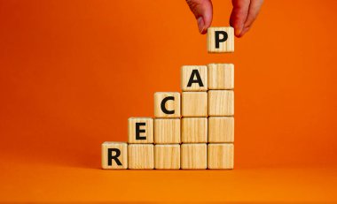 Recap symbol. Wood cubes with word 'recap' stacking as step stair on beautiful orange background, copy space. Male hand. Business and recap concept.