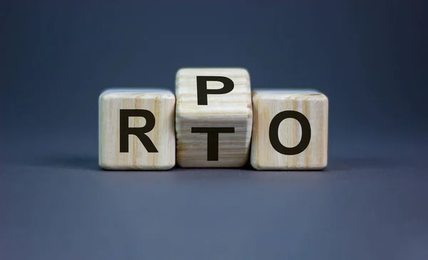 RPO vs RTO. Turned a cube and changed the word 'RTO - recovery time objective' to 'RPO - recovery point objective'. Business and RPO vs RTO concept. Beautiful grey background, copy space.