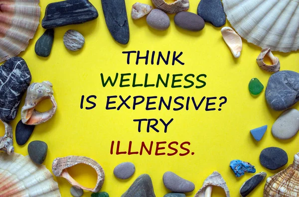 Wellness or illness symbol. Words 'Think wellness is expensive, try illness' on a beautiful yellow background. Sea stones and seashells. Inspirational and motivational quote concept.