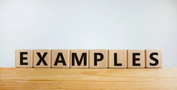 Examples symbol. Concept word 'examples' on wooden cubes on a beautiful wooden block. White background. Business and examples concept. Copy space.