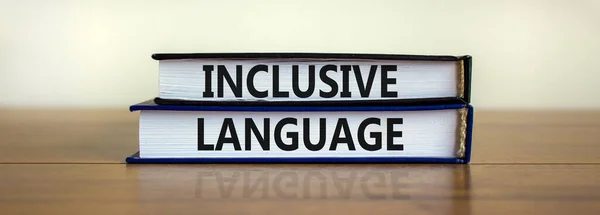 Inclusive language symbol. Books with words \'Inclusive language\' on beautiful wooden table, white background. Business and inclusive language concept. Copy space.