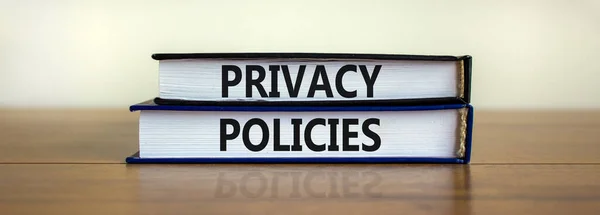 Privacy policies symbol. Concept words \'Privacy policies\' on books on a wooden table. Beautiful white background. Business and privacy policies concept, copy space.