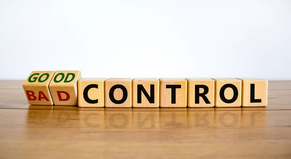 Bad or good control symbol. Turned wooden cubes and changed words 'bad control' to 'good control'. Beautiful wooden table, white background. Business and good control concept. Copy space.