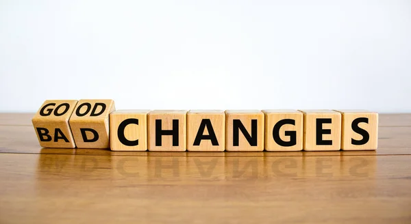 Bad or good changes symbol. Turned wooden cubes and changed words \'bad changes\' to \'good changes\'. Beautiful wooden table, white background. Business and good changes concept. Copy space.