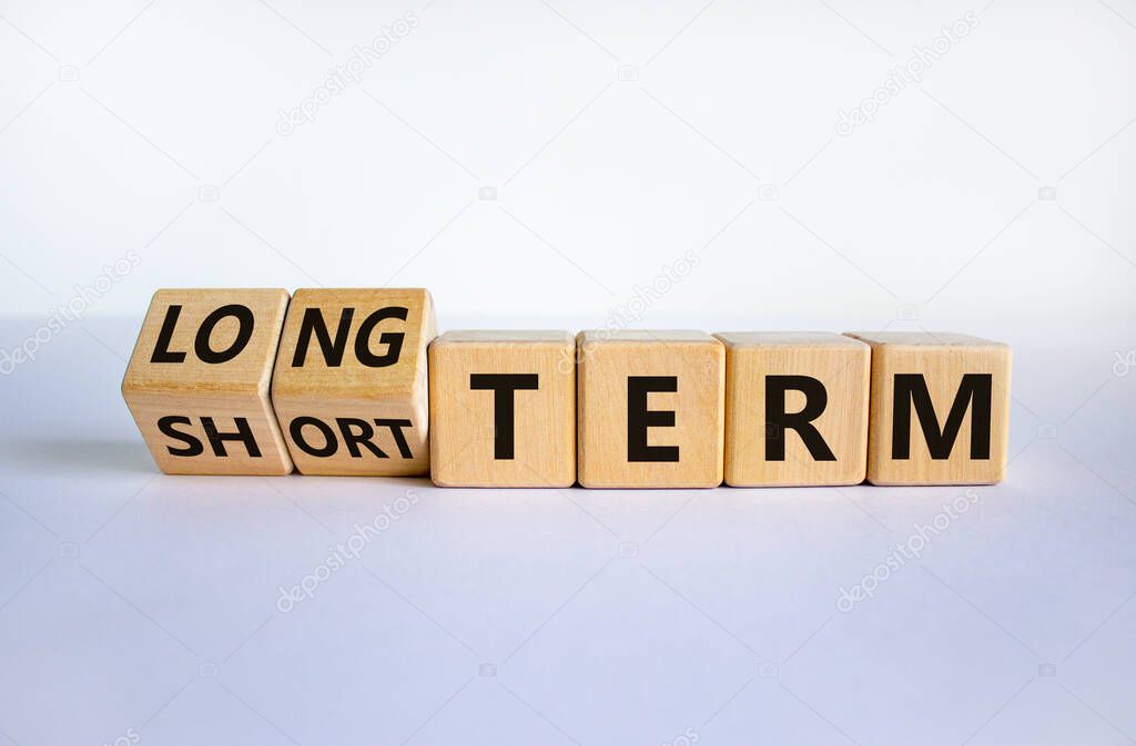Long or short term symbol. Turned cubes and changed words 'short term' to 'long term'. Beautiful white background. Business and long or short term concept, copy space.