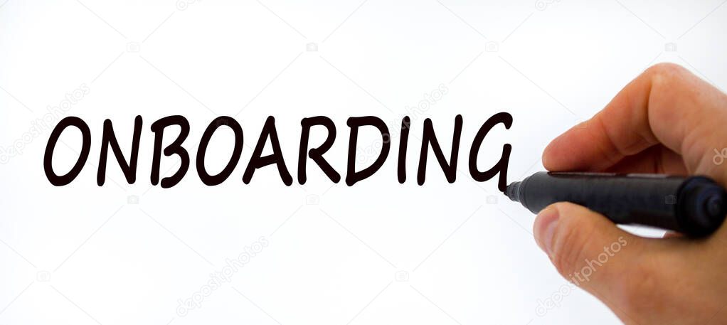 Onboarding symbol. Businessman writing the word 'onboarding', isolated on beautiful white background. Business and onboarding concept, copy space.