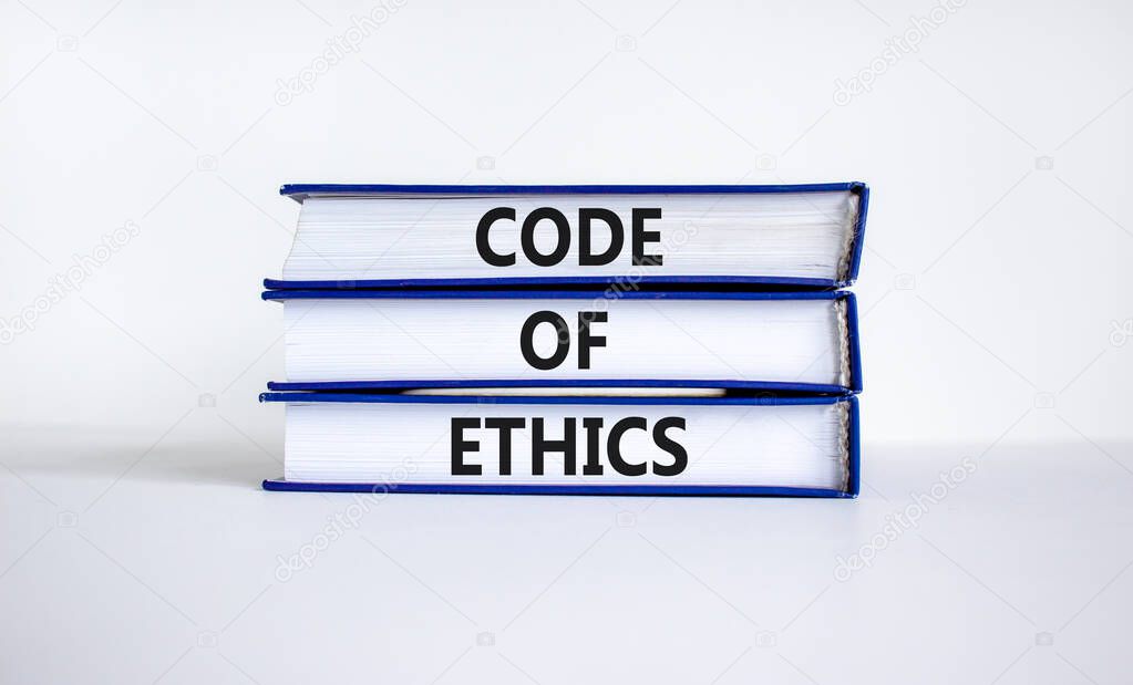 Code of ethics symbol. Books with words 'code of ethics' on beautiful white table, white background. Business and code of ethics concept. Copy space.