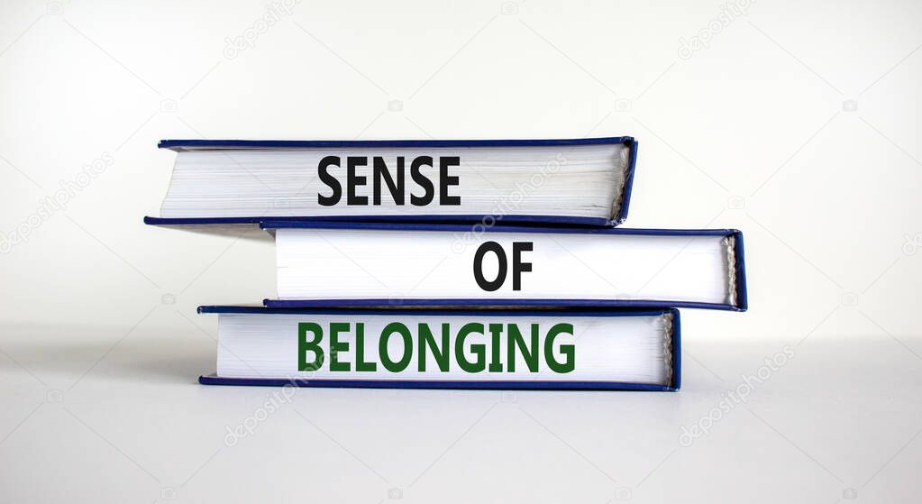 Sense of belonging symbol. Books with words 'sense of belonging' on beautiful white background. Business, sense of belonging concept. Copy space.