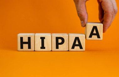 HIPAA, Health Insurance Portability and Accountability Act of 1996 symbol. Words 'HIPAA, Health Insurance Portability and Accountability Act', orange background. Business concept. Copy space.
