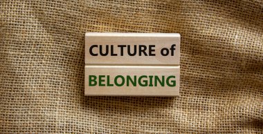 Culture of belonging symbol. Wooden blocks with words 'culture of belonging' on beautiful canvas background. Business, culture of belonging concept. Copy space. clipart