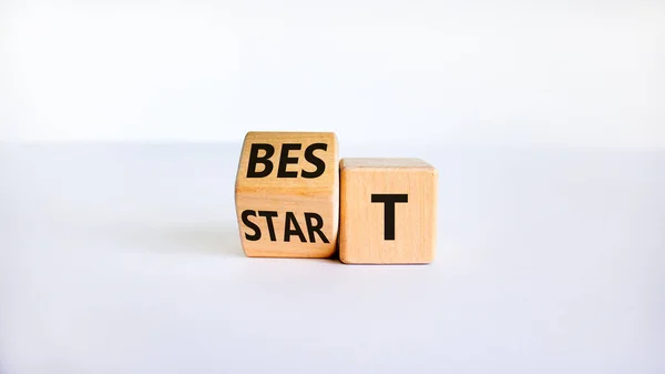 Time to best start symbol. Turned a wooden cube with words \'best start\'. Beautiful white table, white background, copy space. Business and best start concept.