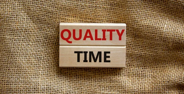 Quality time symbol. Wooden blocks with words 'quality time'. Beautiful canvas background. Business and quality time concept. Copy space.