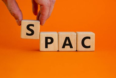 SPAC, özel amaçlı şirket sembolü. Güzel turuncu arka planda 'SPAC' sözcüğüyle ahşap küpler, kopyalama alanı. İş ve SPAC, özel amaçlı satın alma şirketi kavramı.