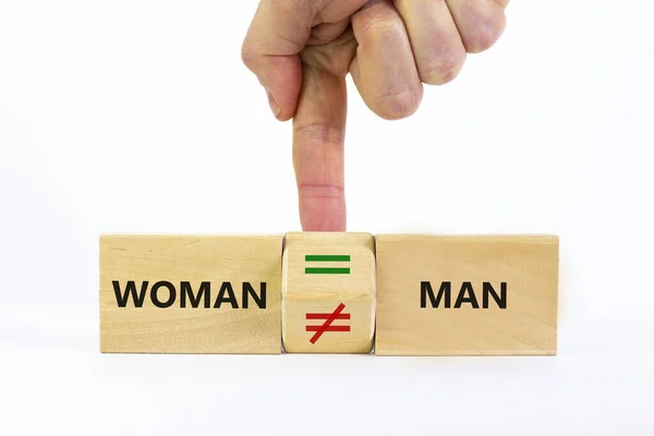 Symbol for gender equality. Businessman turns a cube and changes a unequal sign to a equal sign between men and women. Beautiful white background, copy space. Gender equality concept.