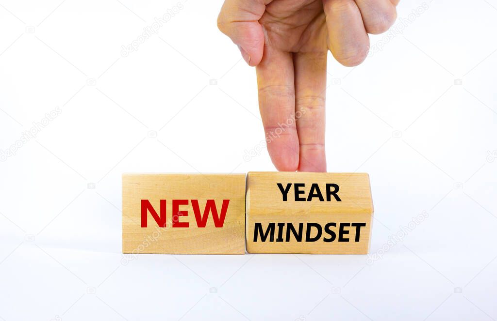 New year and mindset symbol. Businessman turns the wooden block and changes words 'new mindset' to 'new year'. Beautiful white background. Business, new year and mindset concept. Copy space.