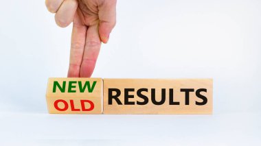 New vs old results symbol. Businessman turns the wooden block and changes words 'old results' to 'new results'. Beautiful white background. Business, new or old results concept. Copy space.