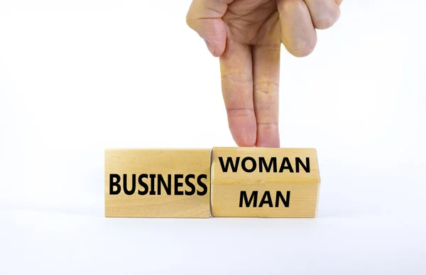 Symbol for gender equality and woman in business. Businessman turns a cube and changes the word businessman to businesswoman. Beautiful white background, copy space. Gender equality concept.