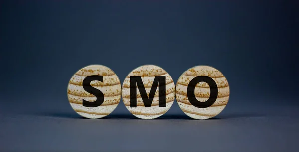 SMO, social media optimization symbol. Wooden circles with word \'SMO - social media optimization\' on beautiful grey background, copy space. Business, SMO - social media optimization concept.