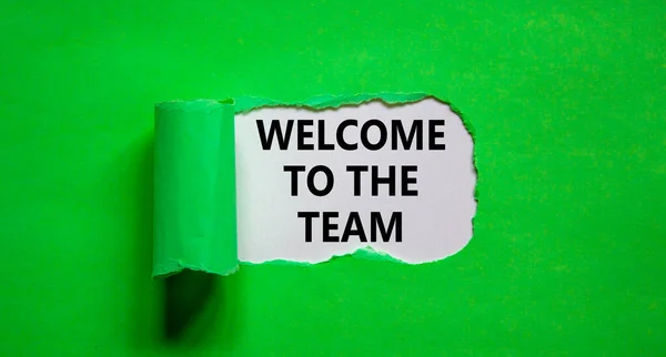 Welcome to the team symbol. Words \'Welcome to the team\' appearing behind torn green paper. Beautiful green background. Business, welcome to the team concept, copy space.