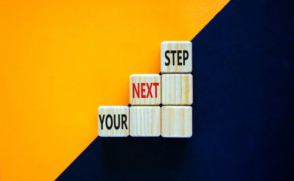 Your next step symbol. Wooden blocks stacking as step stair on top with words Your next Step. Business concept for personal ladder of success process. Orange background, copy space.
