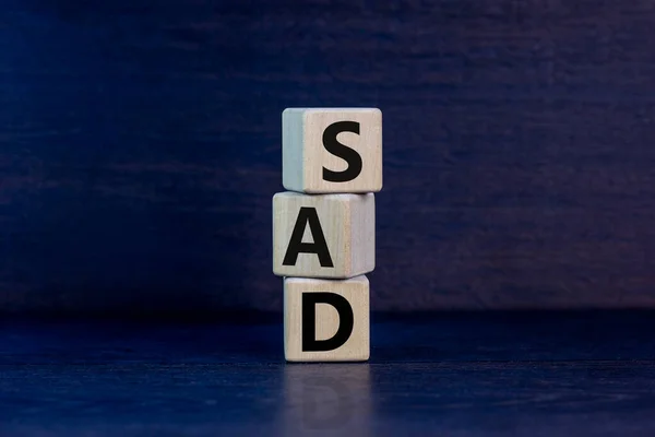 SAD, social anxiety disorder symbol. Concept words 'SAD, social anxiety disorder' on cubes on a beautiful grey background. Medical, psychological and SAD, social anxiety disorder concept. Copy space.