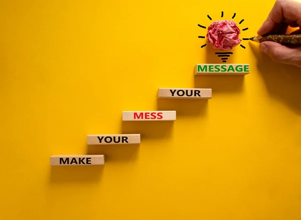 Business concept growth success process. Wood blocks stacking as step stair on yellow background, copy space. Businessman hand. Words \'make your mess your message\'. Conceptual image of motivation.