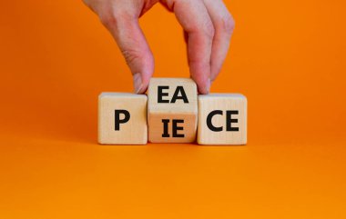 Piece of peace symbol. Businessman turns cubes and changes the word 'piece' to 'peace'. Beautiful orange background, copy space. Business, piece of peace concept.