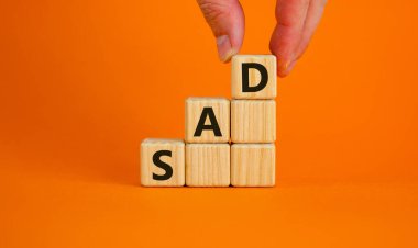 SAD, social anxiety disorder symbol. Concept words 'SAD, social anxiety disorder' on cubes on a orange background. Medical, psychological and SAD, social anxiety disorder concept. Copy space.