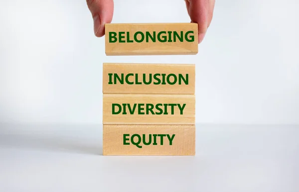 Equity, diversity, inclusion and belonging symbol. Wooden blocks with words \'equity, diversity, inclusion, belonging\' on beautiful white background. Diversity, equity, inclusion and belonging concept.