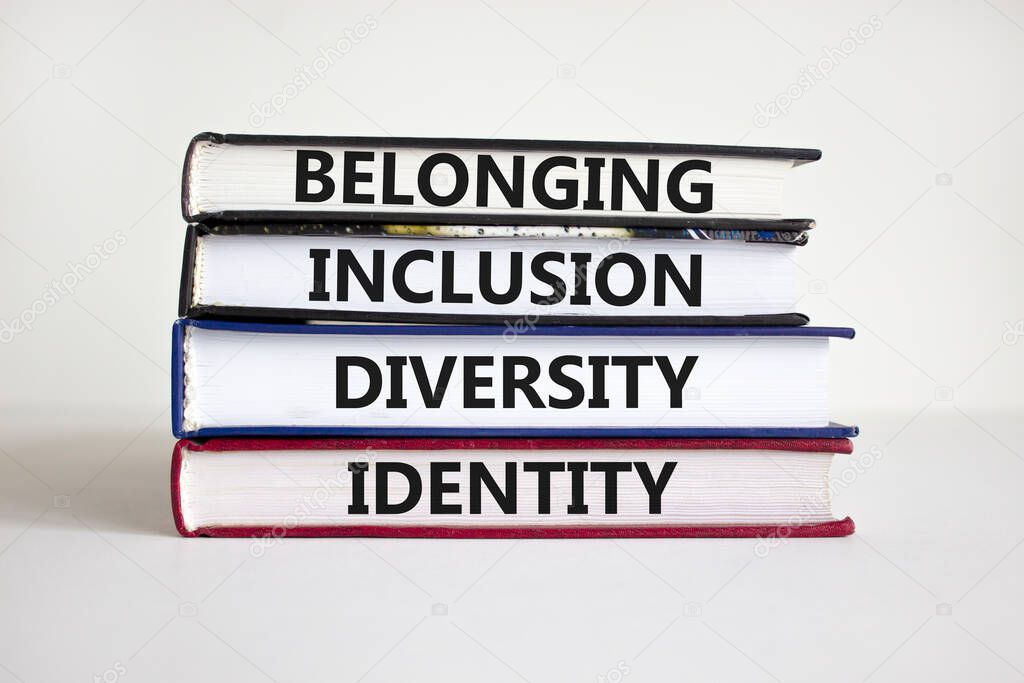 Belonging symbol. Books with words 'belonging, inclusion, diversity identity' on beautiful white table, white background. Business, belonging, diversity and inclusion concept. Copy space.