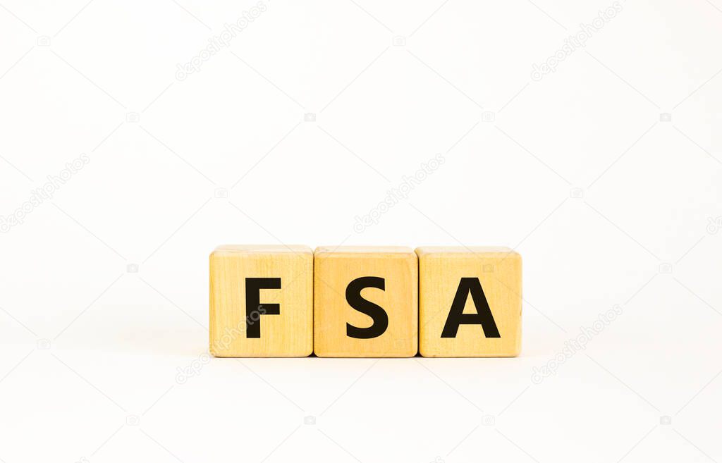 FSA, flexible spending account symbol. Concept word 'FSA, flexible spending account' on cubes on a beautiful white background. Business and FSA, flexible spending account concept. Copy space.