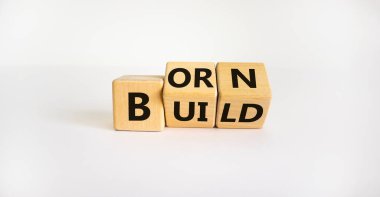 Born or build symbol. Turned wooden cubes and changed the word 'born' to 'build'. Beautiful white background. Born or build and business concept. Copy space.