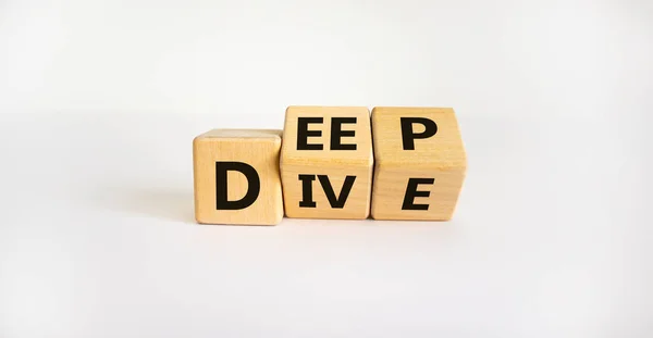 Deep dive symbol. Turned wooden cubes with words \'Deep dive\'. Beautiful white background. Deep dive and business concept. Copy space.
