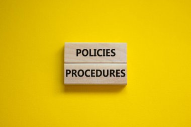 Policies and procedures symbol. Wooden blocks with concept words Policies procedures on yellow background. Business and policies and procedures concept. Copy space. clipart
