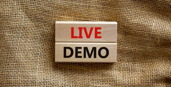 Live demo symbol. Concept words \'live demo\' on wooden blocks on a beautiful canvas background. Copy space. Business and live demo concept.