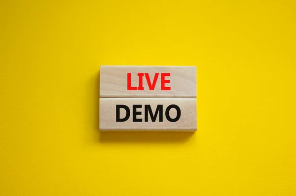 Live demo symbol. Concept words \'live demo\' on wooden blocks on a beautiful yellow background. Copy space. Business and live demo concept.