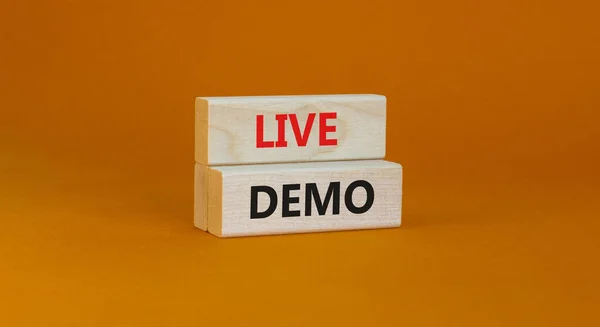 Live demo symbol. Concept words \'live demo\' on wooden blocks on a beautiful orange background. Copy space. Business and live demo concept.