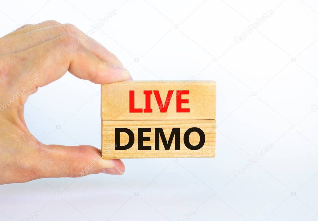 Live demo symbol. Concept words 'live demo' on wooden blocks on a beautiful white background. Businessman hand. Copy space. Business and live demo concept.