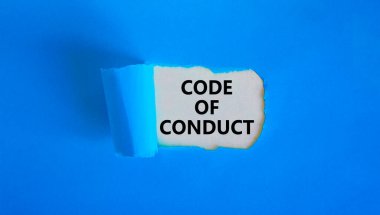 Code of conduct symbol. Words 'Code of conduct' appearing behind torn blue paper. Beautiful blue background. Business, code of conduct concept, copy space.
