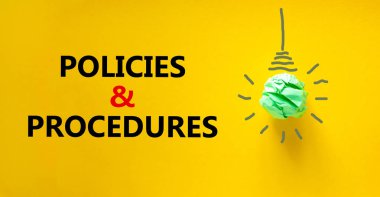 Policies and procedures symbol. Green shining light bulb icon. Words 'Policies and procedures'. Beautiful yellow background. Business and policies and procedures concept. Copy space.