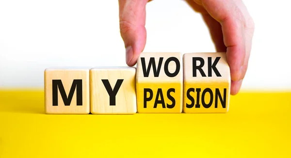 My work or passion symbol. Businessman turns wooden cubes and changes words \'My work\' to \'My passion\'. Beautiful yellow table, white background, copy space. Business and my work or passion concept.