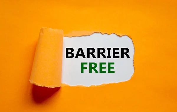 Barrier free symbol. Words \'Barrier free\' appearing behind torn orange paper. Beautiful orange background. Business, diversity, inclusion, belonging and barrier free concept, copy space.