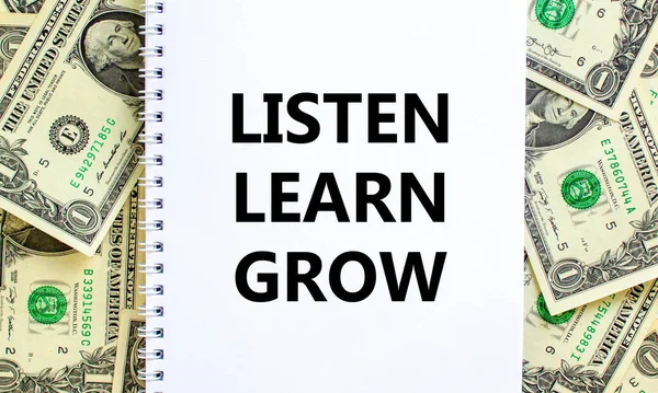 Listen, learn, grow symbol. Words \'Listen, learn, grow\' on white note. Beautiful background from dollar bills. Business, educational, listen, learn, grow concept. Copy space.