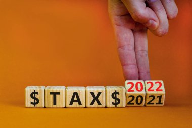 2022 yılbaşı vergisi sembolü. İşadamı ahşap küpleri değiştiriyor ve 